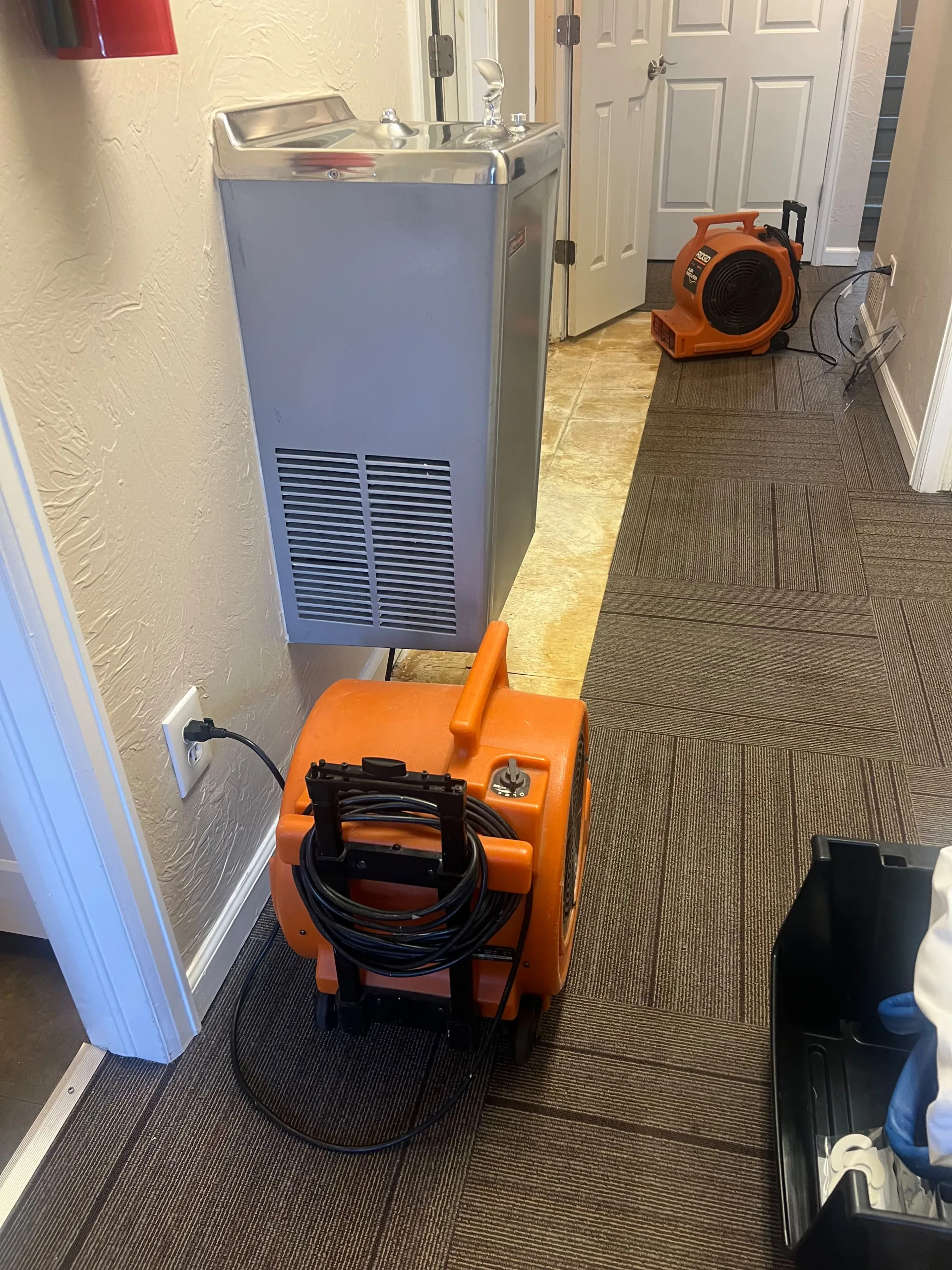 Air mover drying a floor during a reinstallation